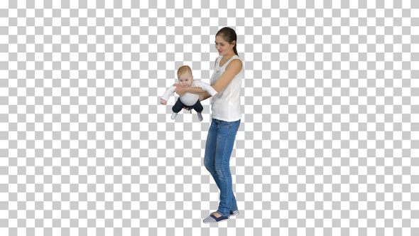 Mother spins her baby on hands Baby flying in mothers hands