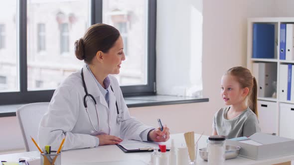 Female Doctor and Little Girl Patient at Clinic