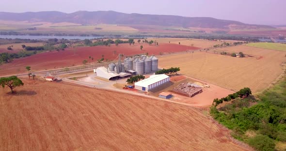 Grains stored in silos in the field. Rice, corn, wheat, soy, cereals. Aerial drone image.