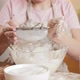 Young Woman in Apron Sifting Flour with Sieve on Kitchen at Home - VideoHive Item for Sale