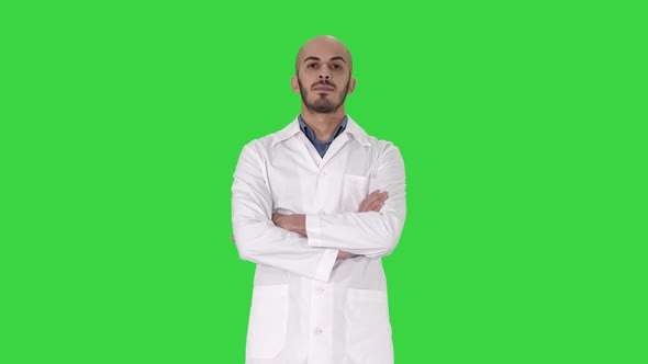 Serious Arabian Doctor Mature Male with Crossed Arms on a Green Screen, Chroma Key.