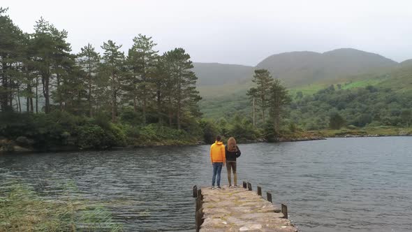 Two Young People Enjoy the Silence in a Park