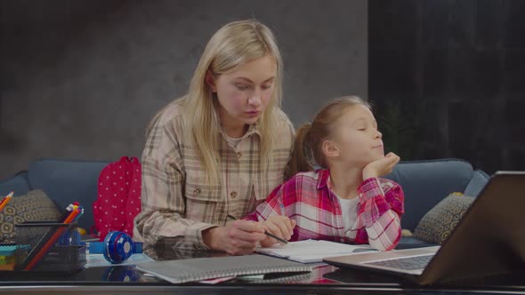 Caring Mother Teaching Math To Lazy Girl Indoors