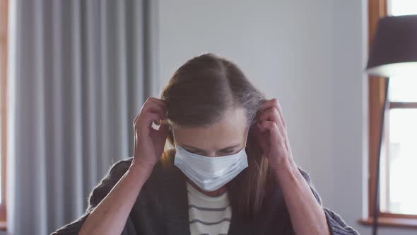 Woman wearing face mask at home