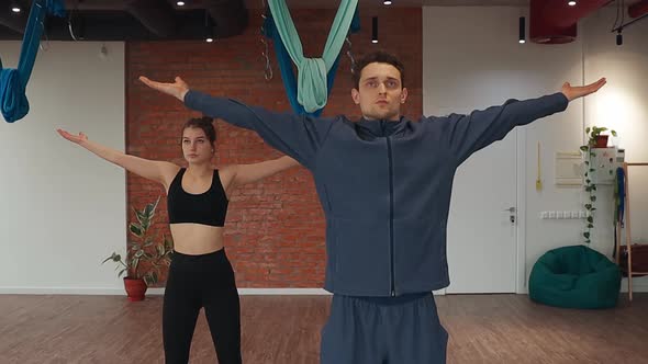 Man and Woman Exercising Healthy Meditation Practicing Prayer Pose in Studio