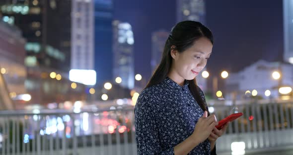 Woman read on mobile phone and sit outside