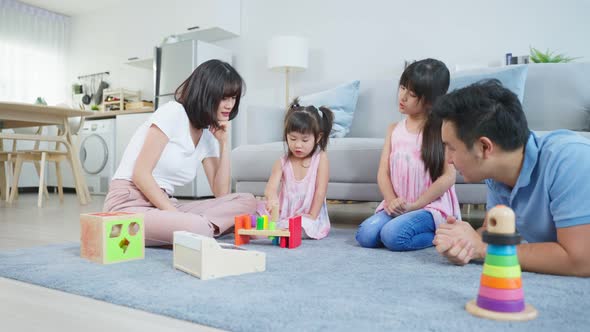 Happy family activity, Asian young kid daughter coloring and painting on paper with parents.