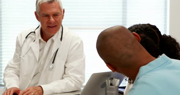 Male doctor and patient interacting with each other