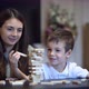 Mother and Son Playing in Board Game with Wooden Tower at Home - VideoHive Item for Sale