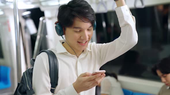 Businessman Using Mobile Phone on Public Train