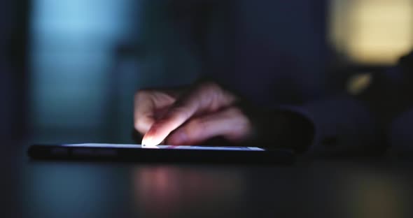 Girl is using a digital tablet at night 