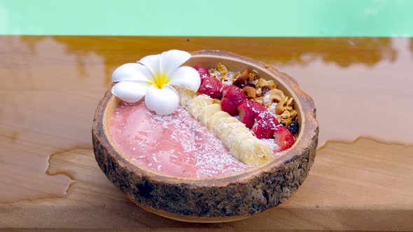 Acai Smoothie Bowl with Banana Strawberries Granola and Coconut Flakes