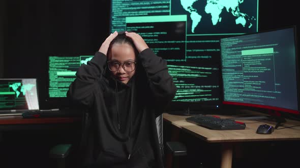 Asian Young Girl Hacker Hacking With Multiple Computer Screens And Pose In Dark Room