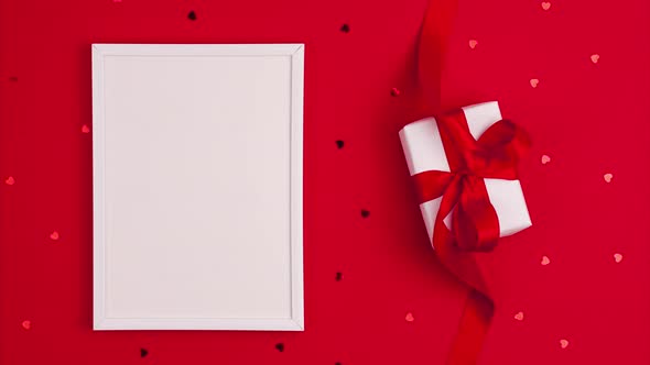 Stop motion animation of mockup white frame flat lay of white gift box with a red satin ribbon bow alt