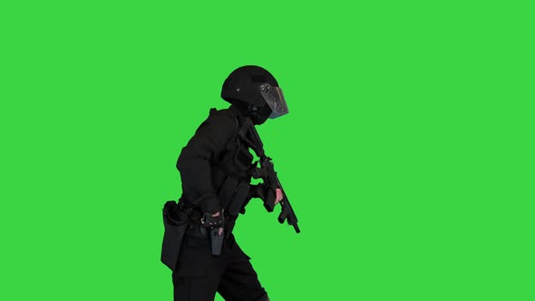 Anti Terrorist Unit Policeman Walking with a Machine Gun and Aiming with a Pistol on a Green Screen
