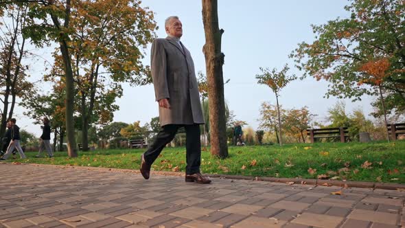 Senior Stroll in Park in Fall