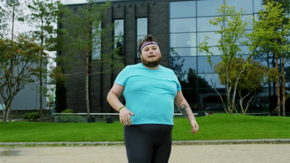 Handsome Fat Young Man Beside of Modern Building