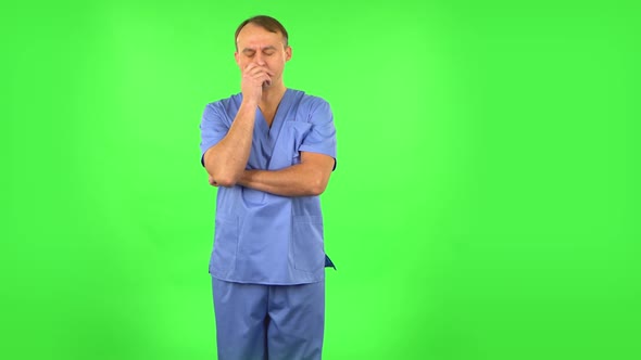 Medical Man Listens Carefully To Boring Information. Green Screen