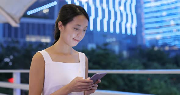 Woman use of mobile phone at night