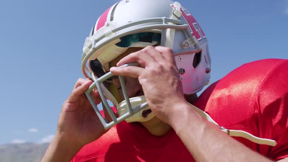 American football player removing helmet