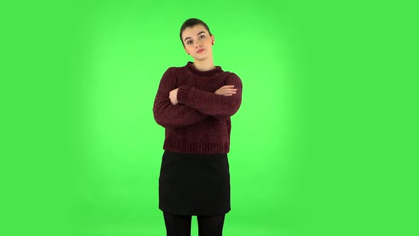 Girl Looking at the Camera with Her Arms Crossed. Green Screen