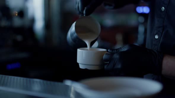 Man Hands Adding Cream to Coffee Closeup