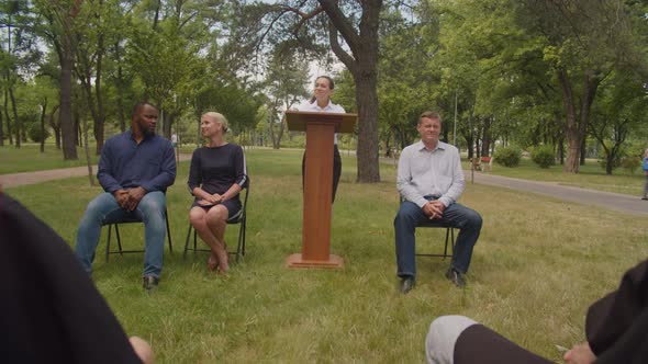 Lovely Female Professor Giving Parting Words to Diverse Graduates at Graduation Ceremony