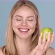 Close Up Studio Shot of Smiling Young Woman Holding Green Apple - VideoHive Item for Sale