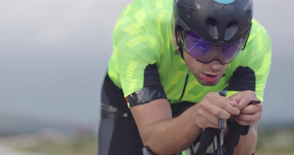 Closeup Shot of Triathlon Sportsman Athlete Cyclist Riding Professional Racing Bicycle