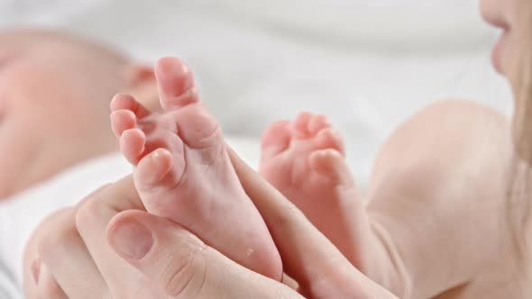 Mom Enjoying Kissing Baby Feet alt