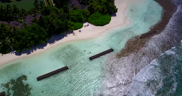 Natural overhead island view of a white sandy paradise beach and blue water background 