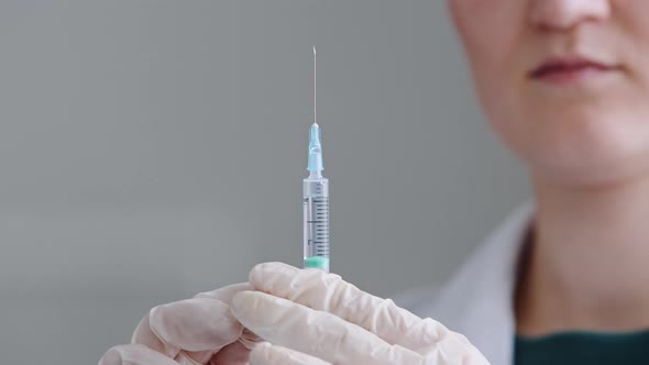 Unrecognizable Woman Doctor Nurse Medical Worker Scientist Wears Latex Gloves Holds Syringe with