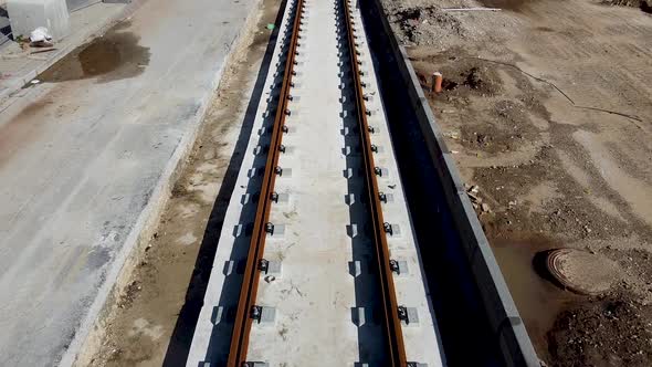 Aerial forward drone shot of an empty light rail tracks on construction in Jaffa, Israel. surrounded