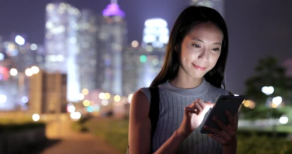 Woman looking at mobile phone in the city