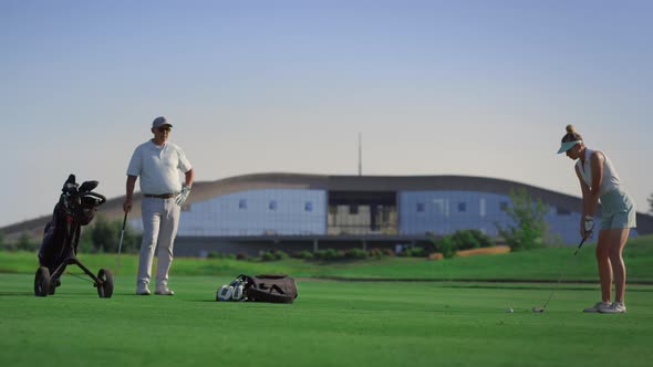 Business Couple Play Golf on Course