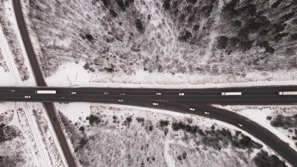 Country Highway with Interchanges and Fast Moving Cars in Winter Aerial View