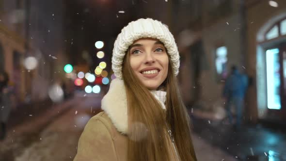 Girl with Dreams in Her Eyes During Snowfall at Night