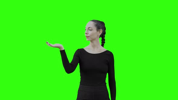 Young Woman Communicate With a Virtual Entity by Blowing Air with Green Screen.