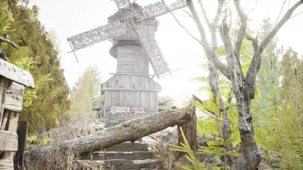 Old Traditional Wooden Windmill in the Forest alt