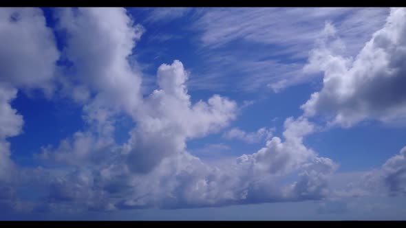 Aerial drone shot seascape of luxury tourist beach journey by blue green lagoon and white sand backg