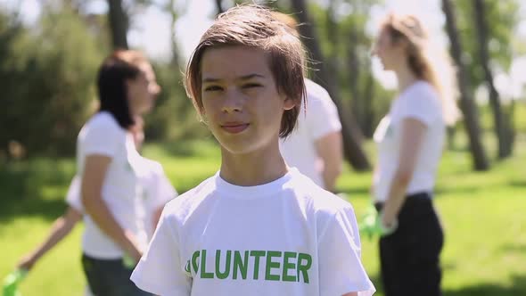 Portrait of Volunteer Boy Posing for Camera While Cleaning at Green Park on Summer Day Spbi