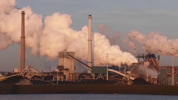 Factory Tata Steel with smoking chimneys on a sunny day in Holland