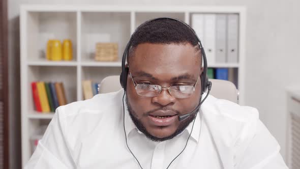 Workplace of freelance worker at home office. Young African-American man.