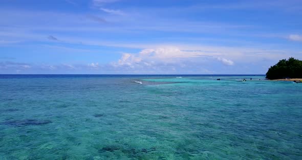 Beautiful overhead copy space shot of a white sandy paradise beach and blue water background in high