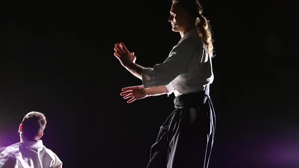 Two Fighters Participants of the Training in Special Clothes of Aikido Hakama Work Out the Methods