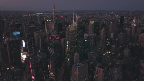 AERIAL: Manhattan Drone Flight at Night with Glowing City Light in New York City 