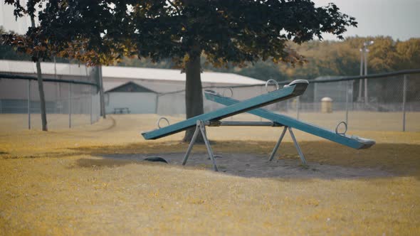 Abandoned Empty Moving Seesaw Teeter Totter In Children's Playground During Autumn 4K ProRes