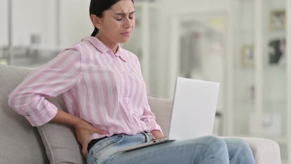Tired Young Latin Woman with Laptop Having Back Pain at Home