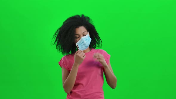 Portrait of Young Female African American Removing the Medical Mask and Sighing with Relief
