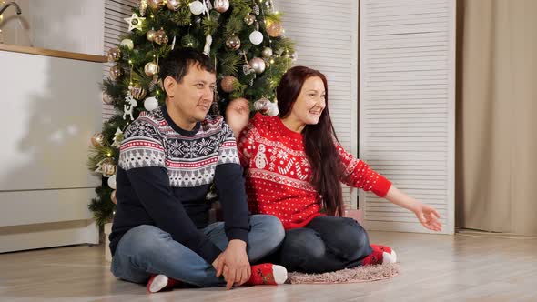 Kid Girl Runs to Mom Dropping Into Arms at Christmas Tree